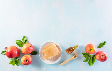 Rosh hashanah (jewish New Year holiday), Concept of traditional or religion symbols on blue pastel wooden background.の写真素材
