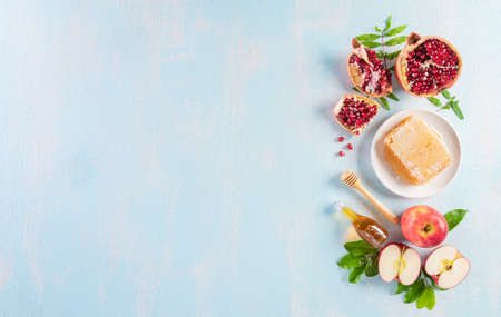 Rosh hashanah (jewish New Year holiday), Concept of traditional or religion symbols on blue pastel wooden background.の写真素材