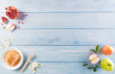 Rosh hashanah (jewish New Year holiday), Concept of traditional or religion symbols on pastel blue wooden background.の写真素材