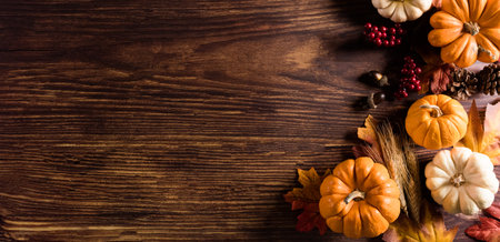Autumn background decoration from dry leaves and pumpkin on old wooden background. Flat lay, top view with copy space for fall and  Thanksgiving concept.の写真素材