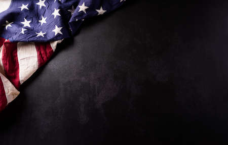 Happy Veterans Day concept. Vintage american flags against black  stone  background. November 11.の写真素材