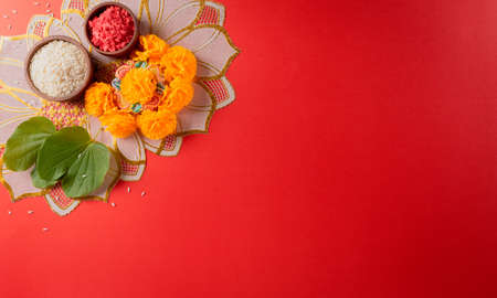 Happy Dussehra. Yellow flowers, green leaf and rice on red background. Dussehra Indian Festival...