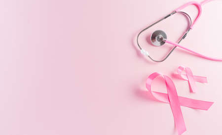 Pink ribbons and stethoscope on pastel background, Symbol of women's breast cancer awareness, Health care and medical concept.の写真素材
