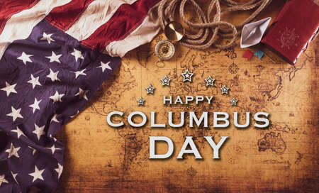 Happy Columbus Day concept. Vintage American flag, compass, paper boat, rope on retro treasure manuscript.の写真素材