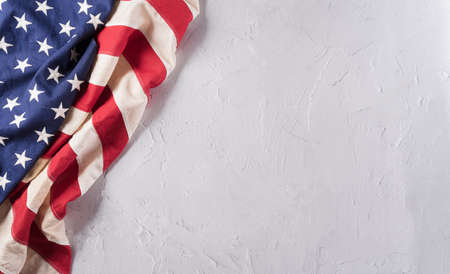 Happy Veterans Day concept. American flags against a white stone  background. November 11.の写真素材