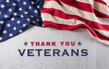 Happy Veterans Day concept. American flags against a white stone  background. November 11.の写真素材
