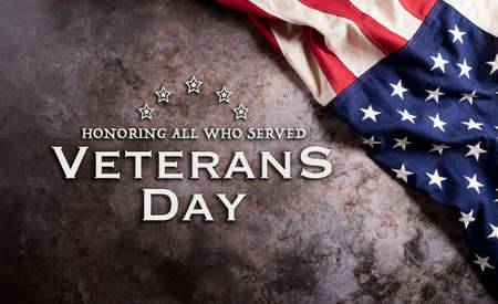 Happy Veterans Day concept. American flags against a dark stone  background. November 11.の写真素材
