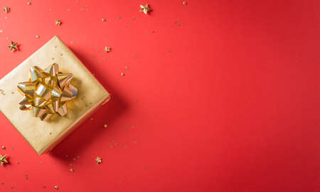 Online shopping of China, 11.11 singles day sale concept. Top view of golden christmas gift boxes with ribbon on red background with copy space.の写真素材