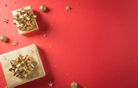 Online shopping of China, 11.11 singles day sale concept. Top view of golden christmas gift boxes with ribbon on red background with copy space.の写真素材