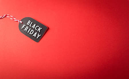 Top view of Black Friday sale tag on red background. Shopping concept boxing day and Black Friday composition.の写真素材