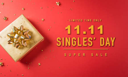 Online shopping of China, 11.11 singles day sale concept. Top view of golden christmas gift boxes with ribbon on red backgroundの写真素材
