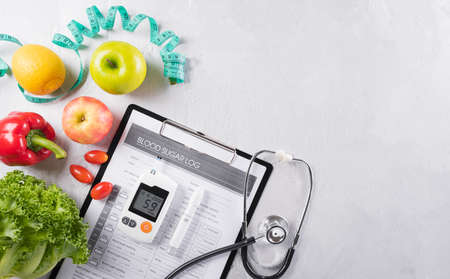 World diabetes day and healthcare concept. Diabetic measurement set, patient's blood sugar control and healthy food eating nutrition in plate on stone background.の写真素材