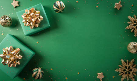 Christmas and new year background concept. Top view of Christmas gift box, christmas ball and snowflake on green background.の写真素材