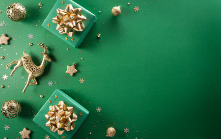 Christmas and new year background concept. Top view of Christmas gift box, reindeer, christmas ball and snowflake on green background.の写真素材