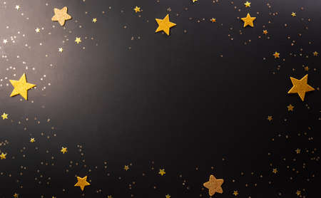Top view of Black Friday sales discount concept in round frame of golden stars on dark background. Flat lay, top view festive shopping background with space for text.の写真素材