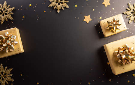 Top view of Black Friday Christmas gift box and golden snowflake on dark background. Shopping concept boxing day and Black Friday composition.の写真素材