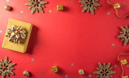 Online shopping of China, 11.11 singles day sale concept. Top view of golden christmas gift boxes with ribbon on red background with copy space.の写真素材