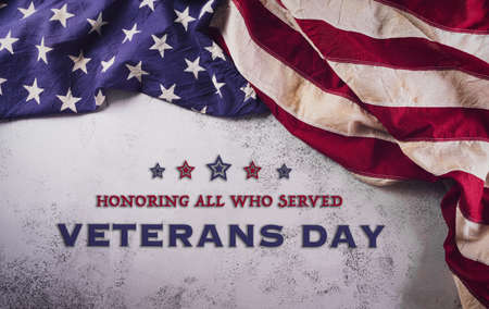 Happy Veterans Day concept. American flags against a white stone  background. November 11.の写真素材