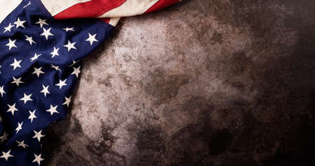 Happy Veterans Day concept. American flags against a dark stone  background. November 11.の写真素材