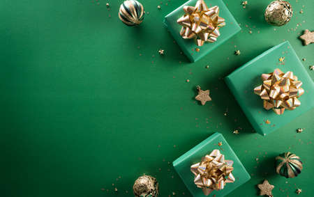 Christmas and new year background concept. Top view of Christmas gift box, christmas ball and snowflake on green background.の写真素材