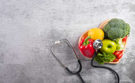 World diabetes day and healthcare concept. Healthy food eating nutrition in plate and stethoscope on stone background.の写真素材