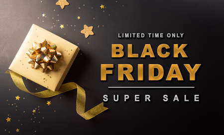 Top view of Black Friday Christmas gift box and ribbon on dark background. Shopping concept boxing day and Black Friday composition.の写真素材