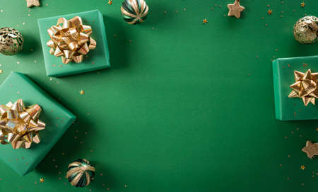 Christmas and new year background concept. Top view of Christmas gift box, christmas ball and snowflake on green background.の写真素材