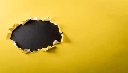 Top view of yellow torn paper on blackboard background. Black Friday composition.の写真素材