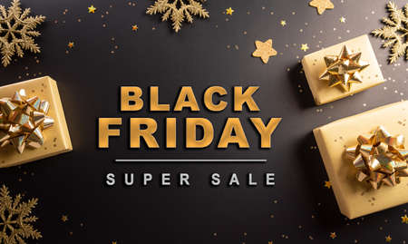 Top view of Black Friday Christmas gift box and golden snowflake on dark background. Shopping concept boxing day and Black Friday composition.の写真素材