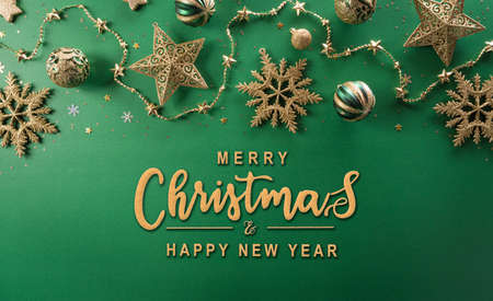 Christmas and new year background concept. Top view of Christmas  ball, star and golden snowflake on green background.の写真素材
