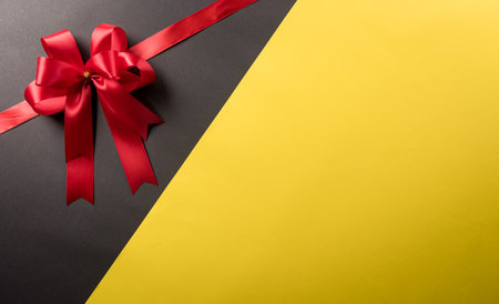 Top view of red ribbon decoration on black and yellow background. Shopping concept boxing day and Black Friday composition.の写真素材