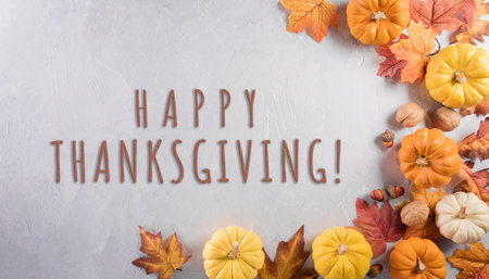 Thanksgiving decoration concept. Pumpkin, autumn leaves and apple with the text on stone background.の写真素材