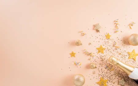 Happy New year celebration background concept. Champagne bottle with golden christmas ball and star...