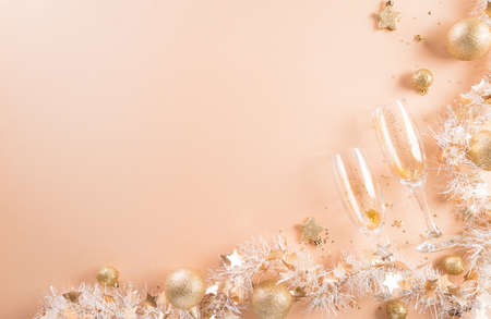 Happy New year celebration background concept. Golden gift box, stars, christmas ball and champagne on pastel background.の写真素材