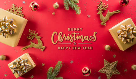 Christmas and new year background concept. Top view of Christmas gift box, reindeer, christmas ball and snowflake on red background.の写真素材