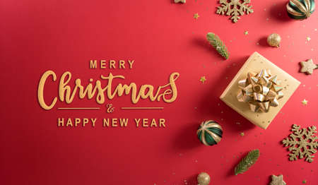 Christmas and new year background concept. Top view of Christmas decoration made from gift box, snowflake, christmas ball and  pine branches on red background.の写真素材