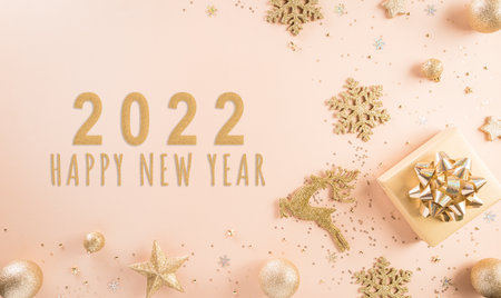 Happy New year celebration background concept. Golden gift box, stars, christmas ball and champagne on pastel background.の写真素材