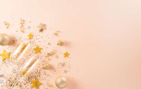 Happy New year celebration background concept. Golden gift box, stars, christmas ball and champagne on pastel background.の写真素材