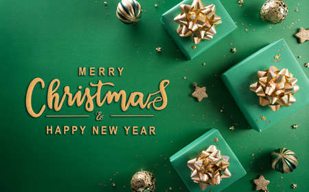 Christmas and new year background concept. Top view of Christmas gift box, christmas ball and snowflake on green background.の写真素材
