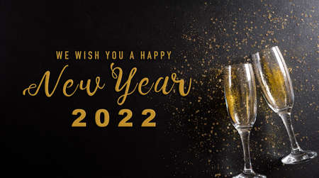 Christmas and New Year holidays background concept made from champagne glasses with golden glitter...