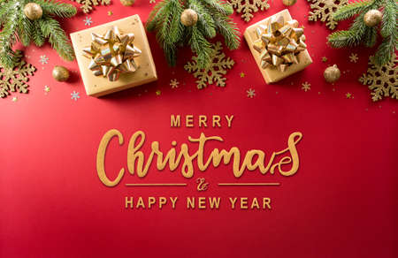 Christmas and new year background concept. Top view of Christmas decoration made from gift box, snowflake, christmas ball and  pine branches on red background.の写真素材