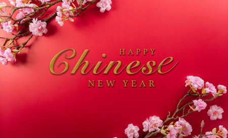 Chinese new year decorations made from plum blossom on a red background. A symbol for fortune, good luck, wealth, money flow.の写真素材