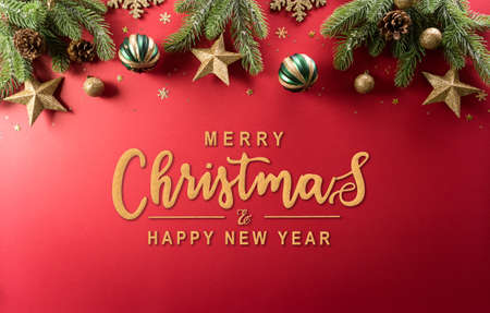 Christmas and new year background concept. Top view of Christmas decoration made from snowflake, christmas ball and  pine branches on red background.の写真素材