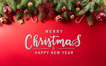 Christmas and new year background concept. Top view of Christmas decoration made from snowflake, christmas ball and  pine branches on red background.の写真素材