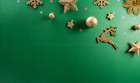 Christmas and new year background concept. Top view of christmas ball, reindeer, star and snowflake on green background.の写真素材