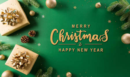 Christmas and new year background concept. Top view of Christmas gift box, christmas ball and snowflake on green background.の写真素材