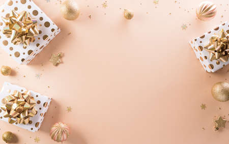 Happy new year celebration background concept made from champagne and glasses, gift box and christmas ball on pastel background.の写真素材