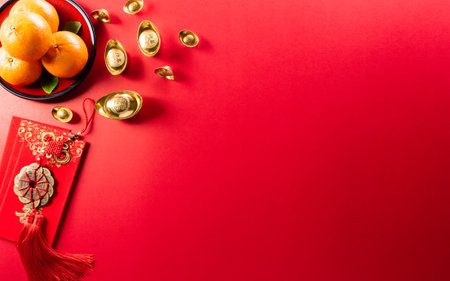 Chinese new year decorations made from red packet, orange and gold ingots or golden lump on a red background. Chinese characters FU in the article refer to fortune good luck, wealth, money flow.の写真素材