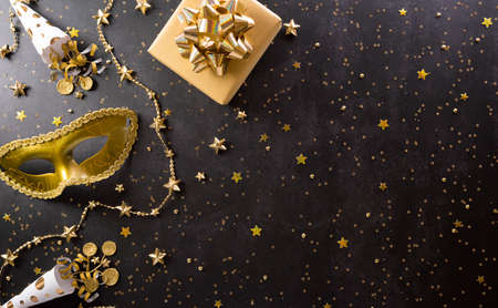Happy Purim carnival decoration concept made from golden mask, wine, gift box and sparkle star on...