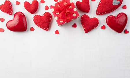 Happy Valentines day and love decoration concept. handmade red hearts with red gift box on white wooden background.の写真素材